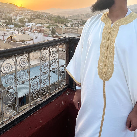 White and gold Moroccan Gandoura in Fes, Morocco overlooking the sunset