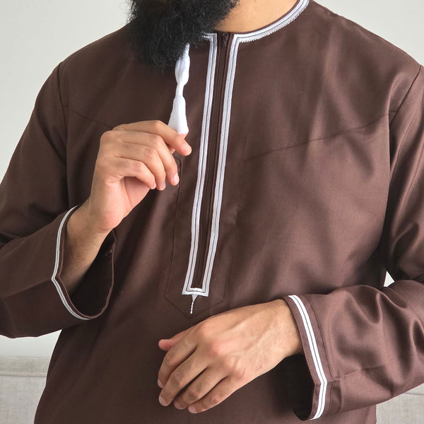 Brown Omani thobe with white embroidery and traditional tassel worn for prayer, Ramadan and Eid in the UK