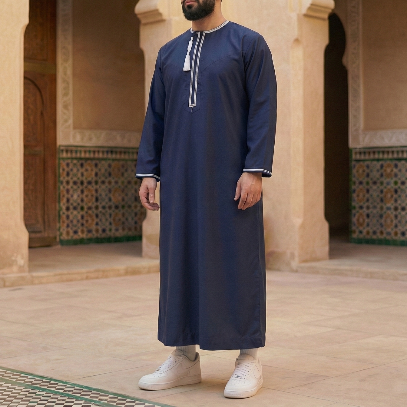 man wearing nayy blue omani thobe with detachable tassel