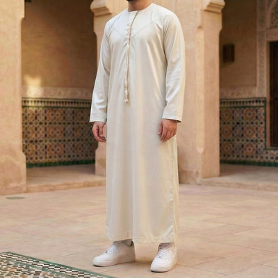 off white Emirati thobe with detachable tassel